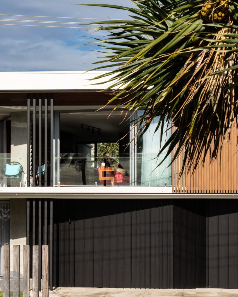 Harbour Parade renovated facade with timber screening, balcony and pandanus tree